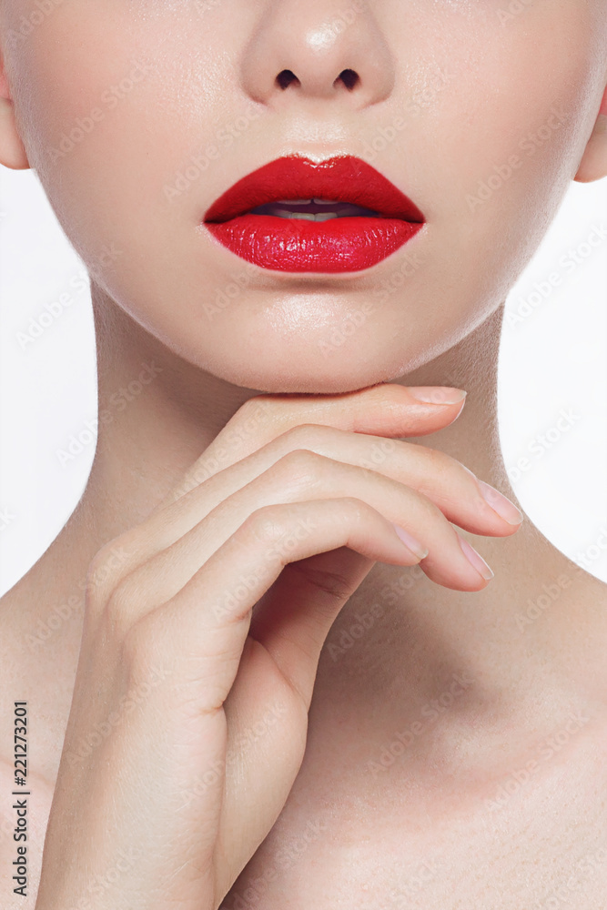 Close-up of female plump red lips and clean skin. The model touches the hand demonstrating skin care. Beauty and spa procedures, injections and lip augmentation Close-up of female plump red lips and clean skin. The model touches the hand demonstrating skin care. Beauty and spa procedures, injections and lip augmentation