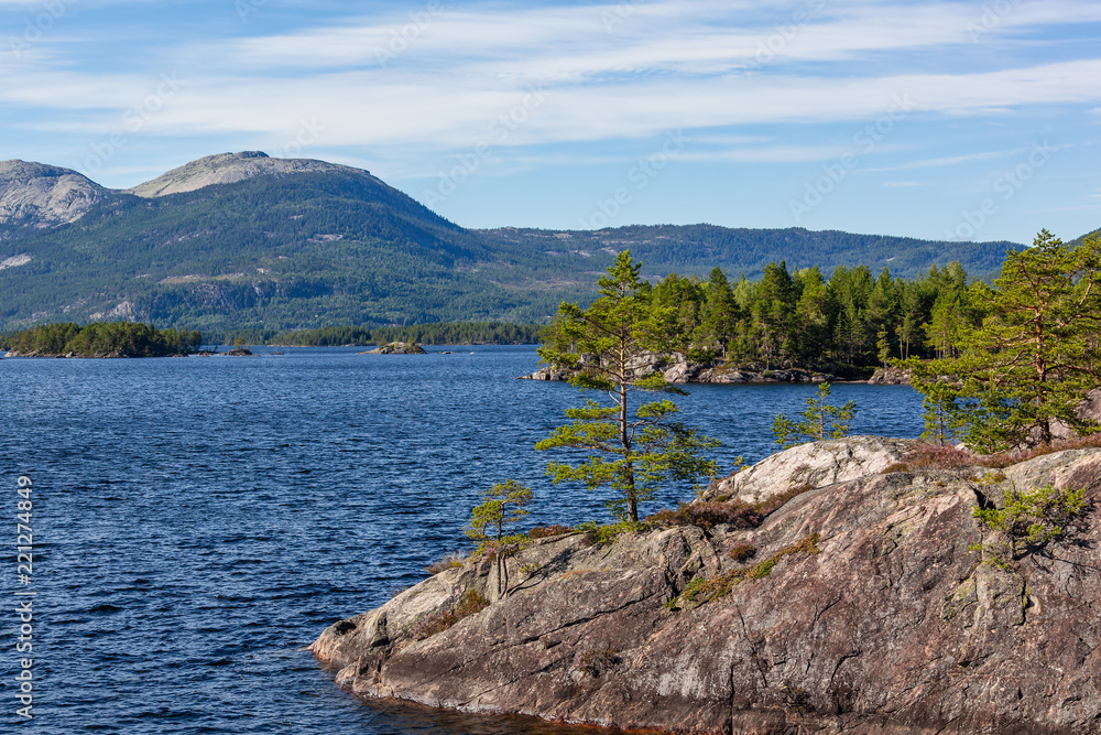 Blue lake with stony shores in the mountain valley, Telemark region, Southern Norway Blue lake with stony shores in the mountain valley, Telemark region, Southern Norway