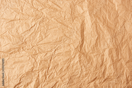 full frame of beige crumpled paper as background