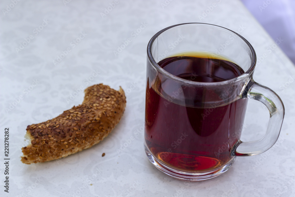 Close-up shoot of Turkish tea in big transparent glass with turkish breakfast food Close-up shoot of Turkish tea in big transparent glass with turkish breakfast food