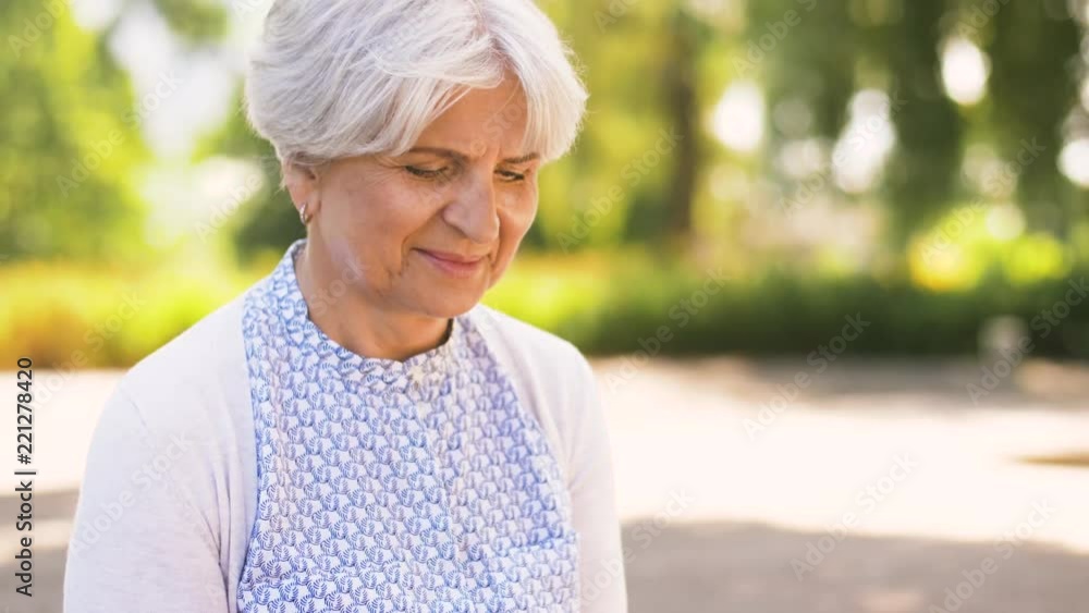 technology, old age and people concept - happy senior woman with smartphone at summer park technology, old age and people concept - happy senior woman with smartphone at summer park