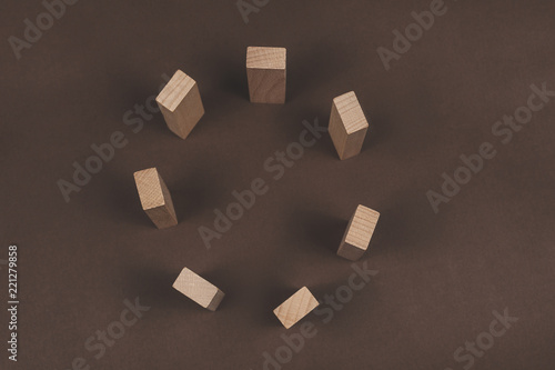 Wooden block in circle on brown background