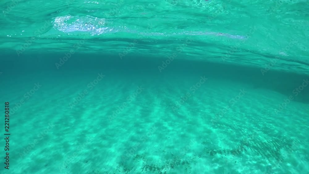 SLOW MOTION, UNDERWATER, POV: Diving alone in the breathtaking turquoise ocean on a sunny day in summer. Cinematic shot of young male tourist swimming breaststroke right under the glimmering surface. SLOW MOTION, UNDERWATER, POV: Diving alone in the breathtaking turquoise ocean on a sunny day in summer. Cinematic shot of young male tourist swimming breaststroke right under the glimmering surface.