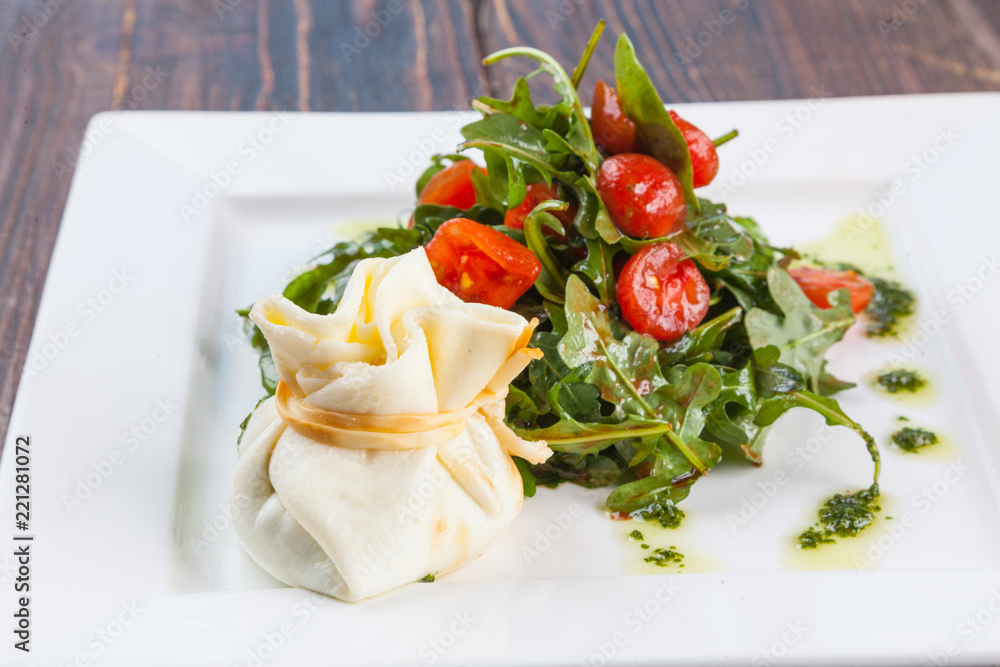 Salad with cherry tomatoes and Arugula with cheese bag
