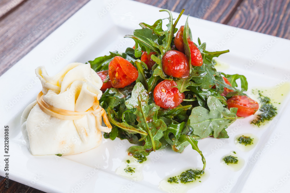 Salad with cherry tomatoes and Arugula with cheese bag Salad with cherry tomatoes and Arugula with cheese bag