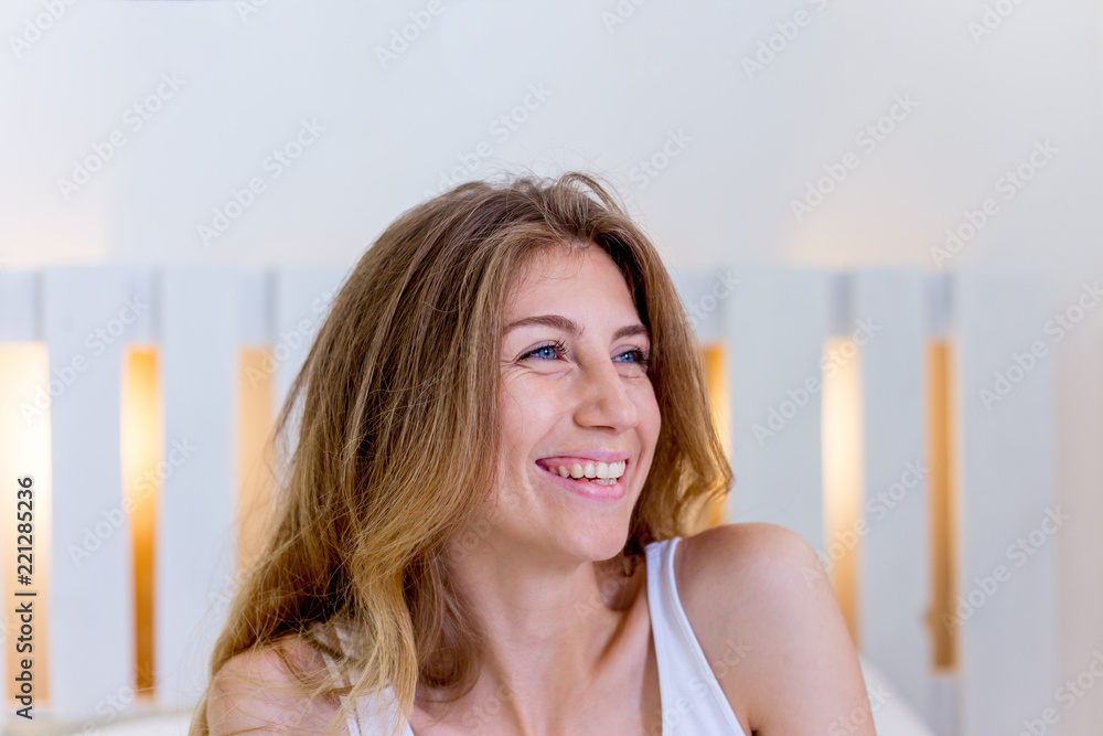 a portrait of a woman stretching in bed after wake up