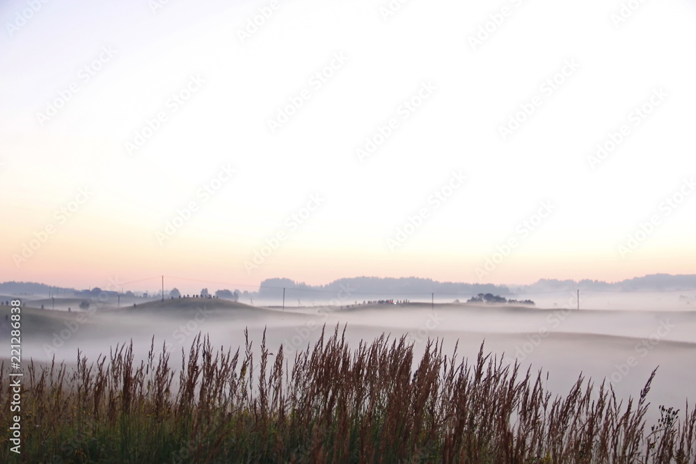 Colorful sunrise over rolling hills in the fog Colorful sunrise over rolling hills in the fog