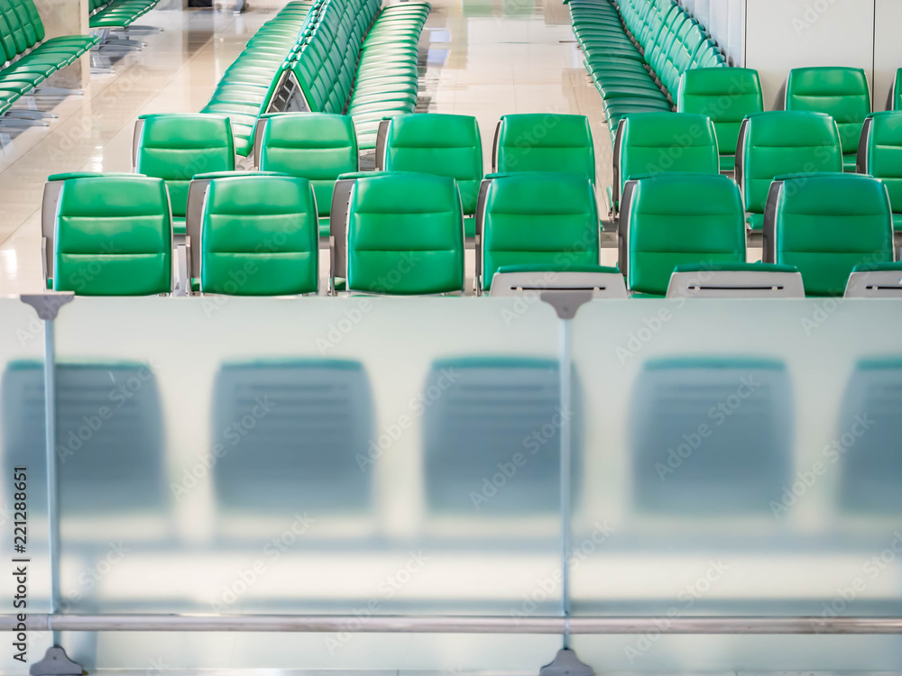 Fototapeta premium Green airport waiting chairs or seating within the terminal.