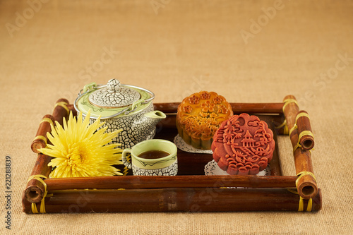 Tray with tasty tea and round moon cakes for mid autumn festival