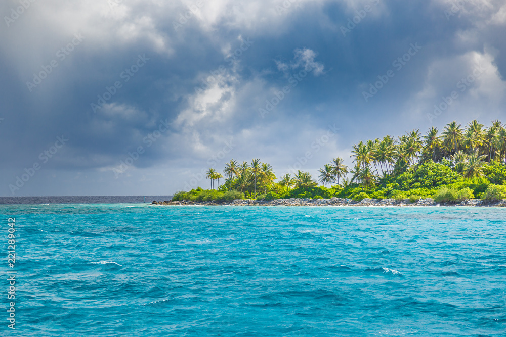 Panorama of tropical island with coconut palm trees on sandy beach. Maldives, Indian Ocean. Panorama of tropical island with coconut palm trees on sandy beach. Maldives, Indian Ocean.