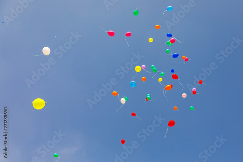 Multicolored balloons flying at sky