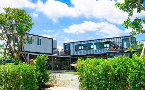 Modern metal building made from shipping house containers and blue sky background .