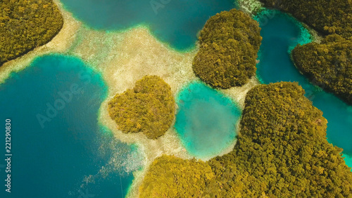 Aerial view: Bucas Grande Island, Sohoton Cove. Philippines. Tropical sea bay and lagoon, beach. Tropical landscape hill, clouds and mountains rocks with rainforest. Azure water of lagoon. Shore photo