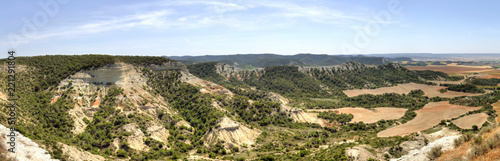 A spanish landscape with cultivated fields, mountains and trees in the Aragon region