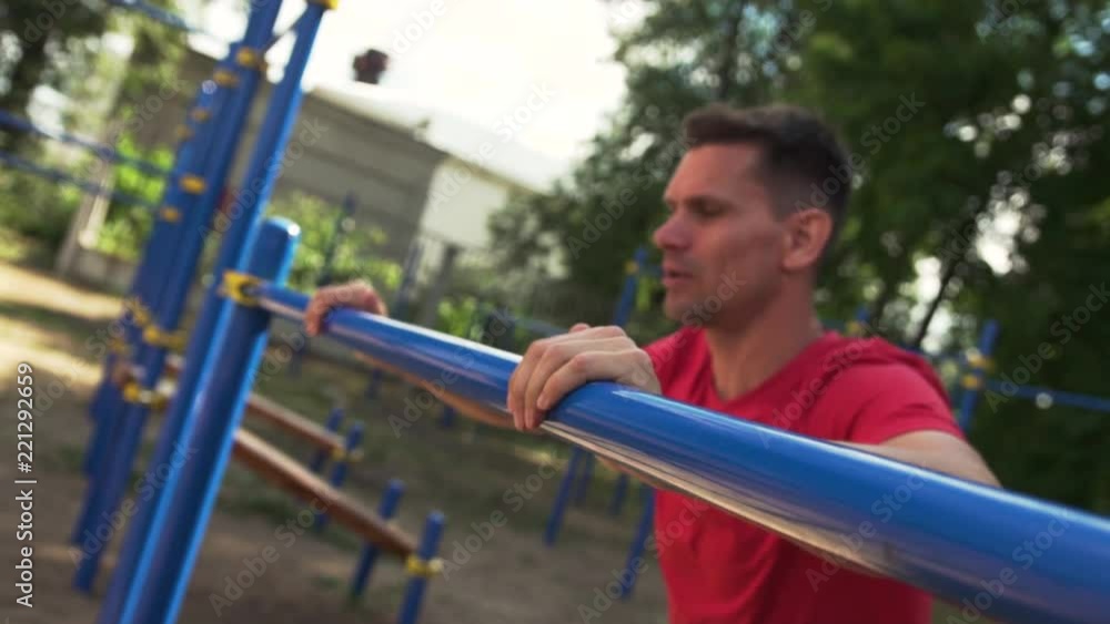 Street Workout. Close-up - Sporty Man Doing Push Ups Exercise in Outdoor Gym. Sports and Fitness. Slow Motion Street Workout. Close-up - Sporty Man Doing Push Ups Exercise in Outdoor Gym. Sports and Fitness. Slow Motion