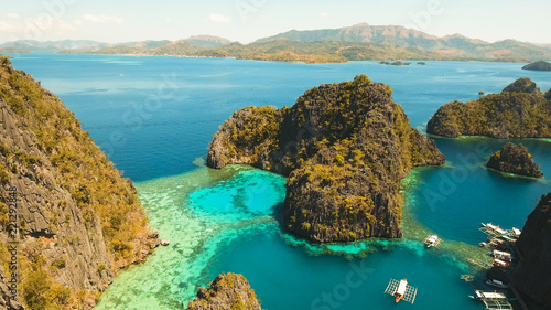 Tropical lagoon with azure water, beach by the Kayangan Lake, Philippines. Aerial view Coron island, with cove, bay at Kayangan lake. Lagoon with sailing boats. Aerial video. Philippines. Travel