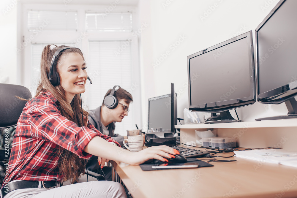 Colleagues working in office with headset Colleagues working in office with headset