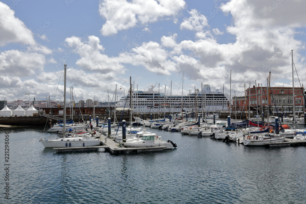 The piers of La Coruña marina sea port with many sailing boats and a blue sky with some clouds