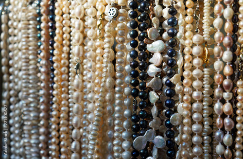 Long beads of natural river pearls in a street shop.