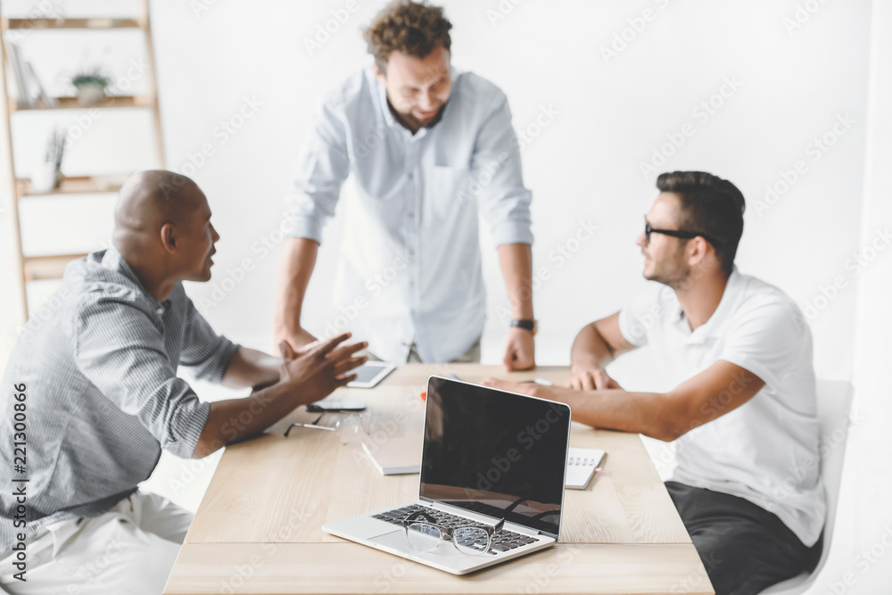 multiethnic businessmen discussing new business idea at workplace on meeting