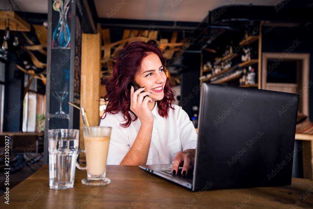 Young student girl working with laptop at coffee shop Young student girl working with laptop at coffee shop