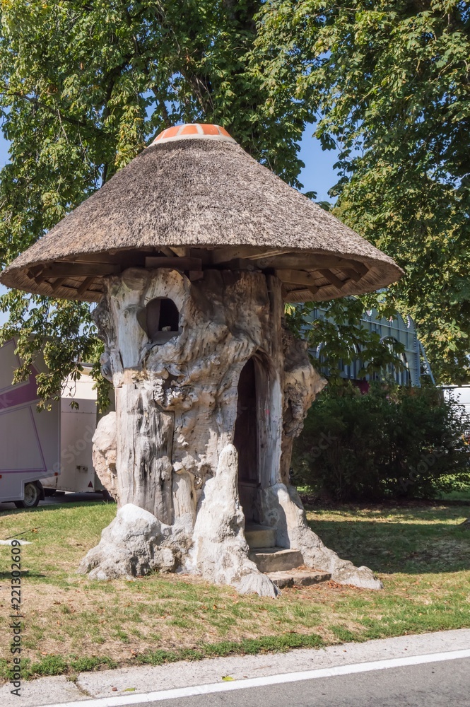 Trunk of an old hollow linden transform into a cottage Trunk of an old hollow linden transform into a cottage