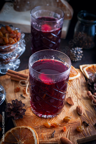 Scandinavian hot alcoholic drink with cinnamon in a glass cup on a wooden board, selective focus photo