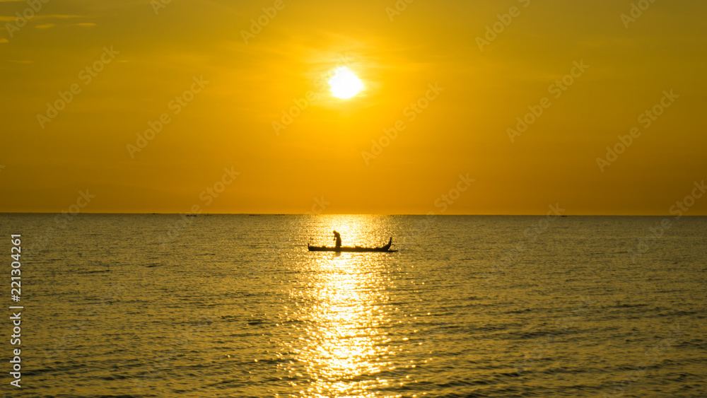 Silhouette of fisherman with sunset view