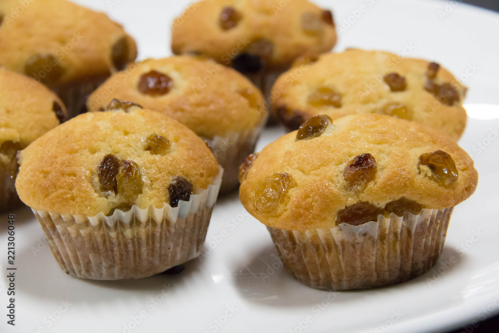  raisin muffin on a white background.