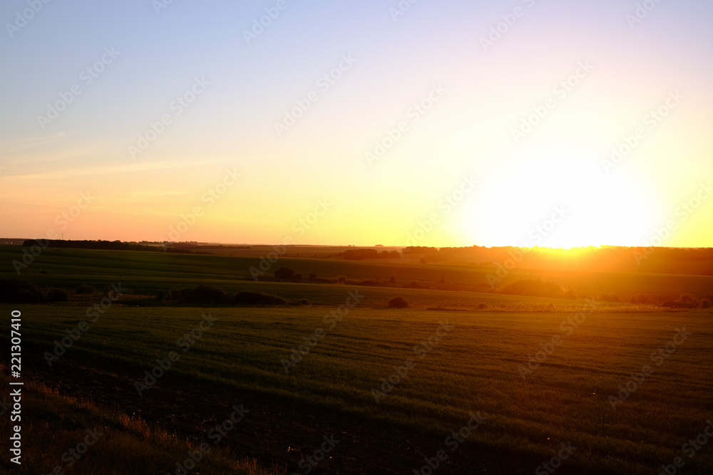 Sunset above field.
