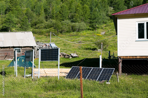 Solar panels on a weather station in the mountains. The weather station building is weather forecasters, powered by solar panels.