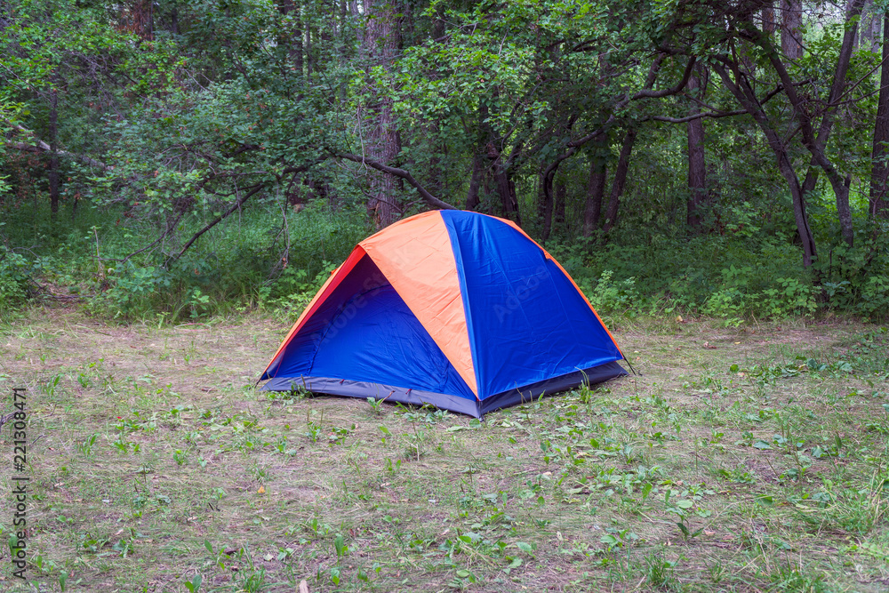 Tourist tent on the background of the forest Tourist tent on the background of the forest