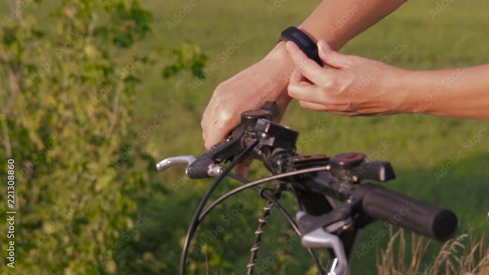 A cyclist with a fitness bracelet. Doing sports with smart watches. On a bicycle with a fitness bracelet. A cyclist with a fitness bracelet. Doing sports with smart watches. On a bicycle with a fitness bracelet.