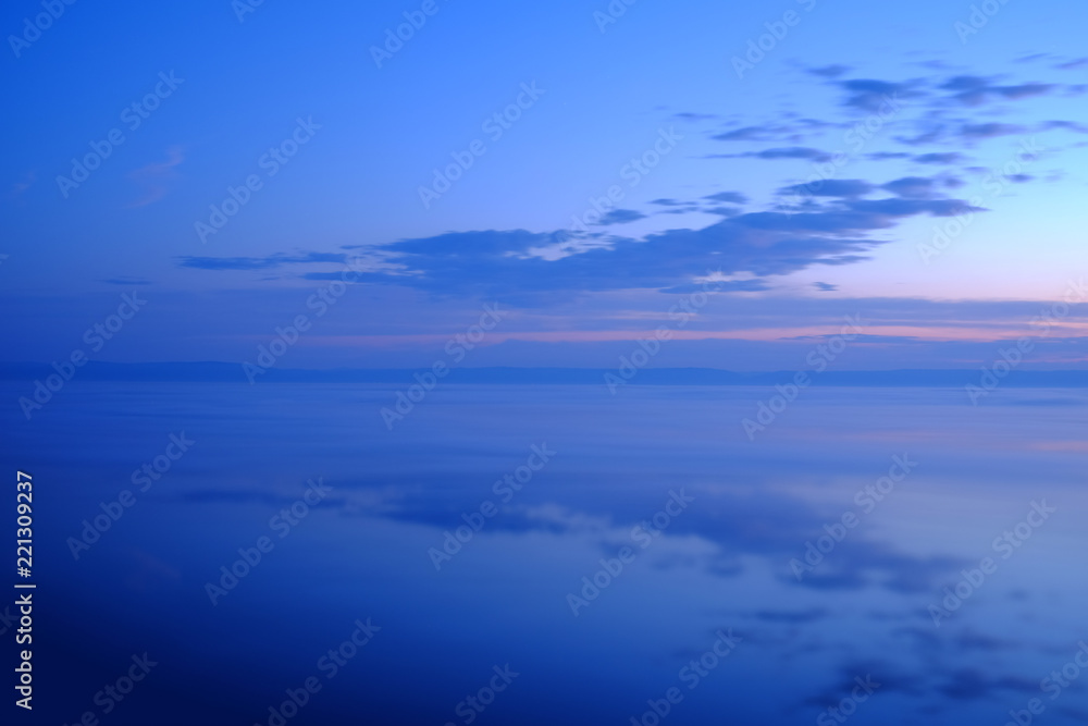 Beautiful sunset over sea with reflection in the water.