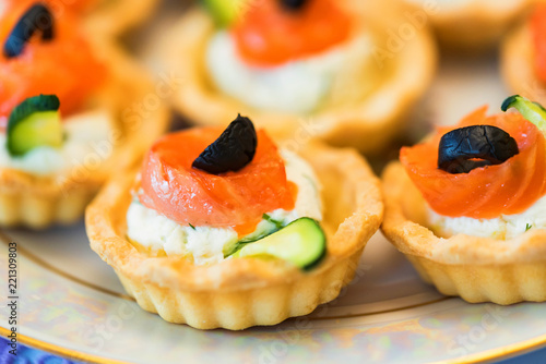 Tartlets with cheese  salmon and olives close