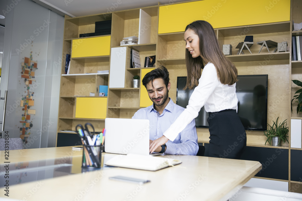 Young businesswoman and businessman working in modern office Young businesswoman and businessman working in modern office