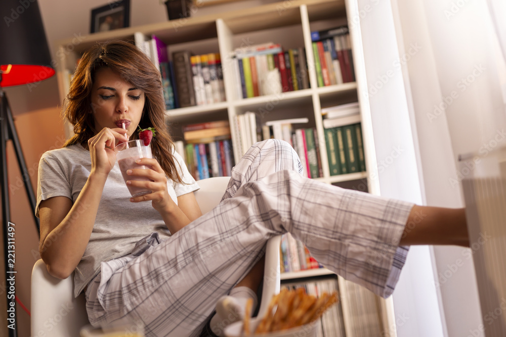 Woman drinking strawberry smoothie Woman drinking strawberry smoothie