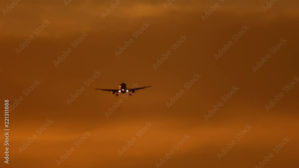 The aircraft flies in the sky in the sunset light The aircraft flies in the sky in the sunset light