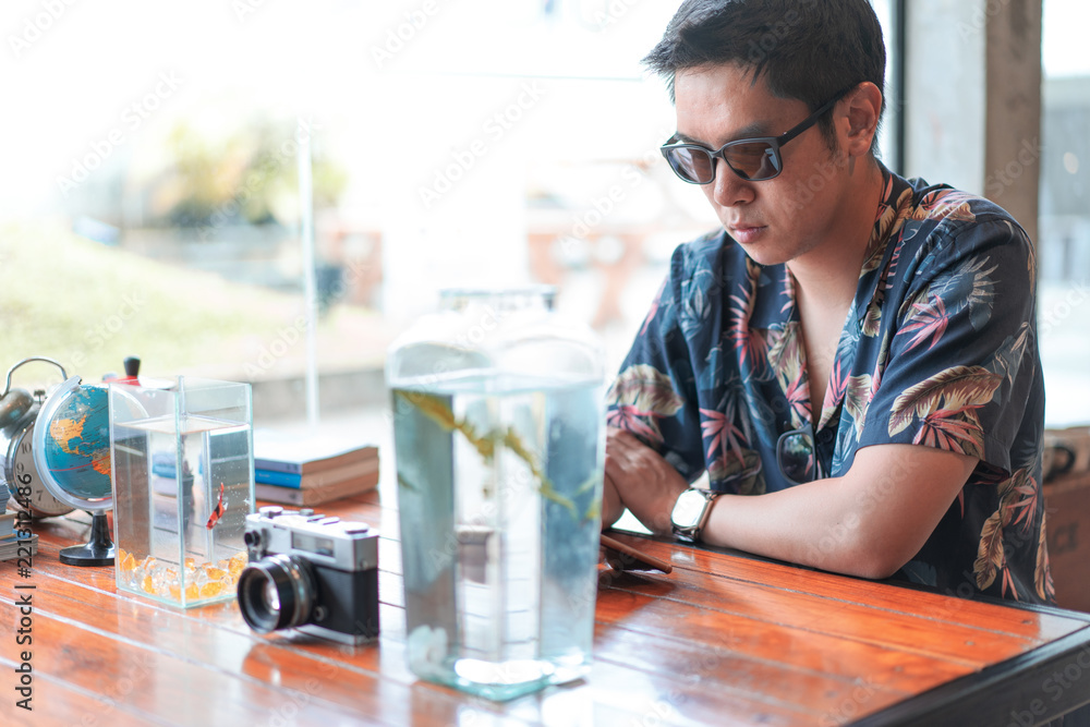 A hipster boy with sunglasses is drinking hot coffee. A hipster boy with sunglasses is drinking hot coffee.