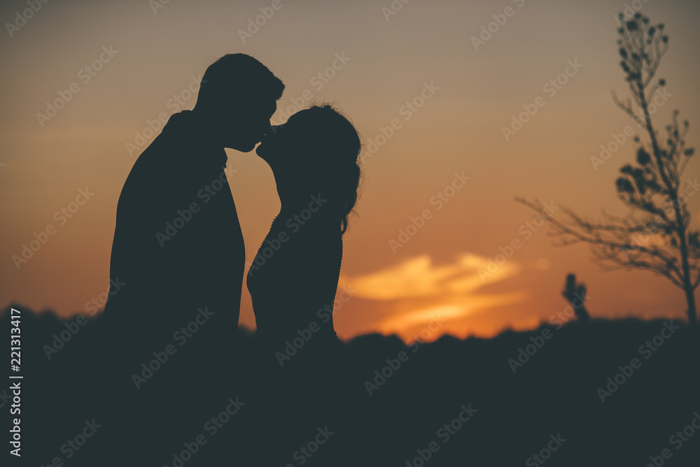loving couple in silhouette on the sunset