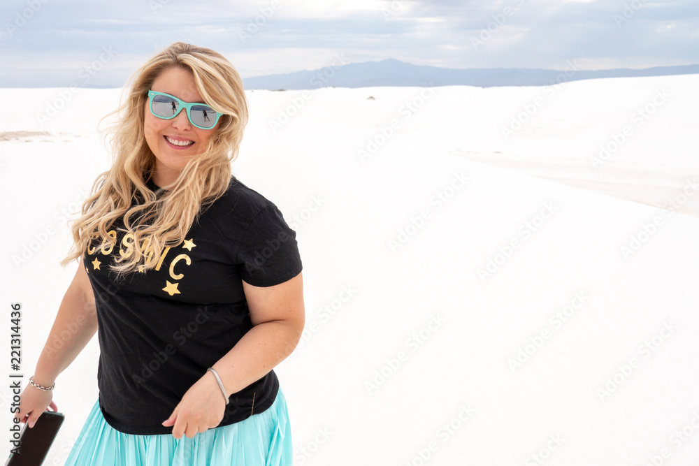 Beautiful blonde woman smiles and poses at White Sands National Monument in New Mexico Beautiful blonde woman smiles and poses at White Sands National Monument in New Mexico
