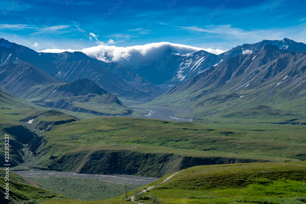 View of the Alaska Range mountains from Polychrome Pass in Denali National Park. Thunderclouds and a storm moves in on a peak