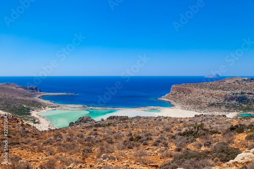 Balos lagoon (Balos beach) on Crete island. Tourists relax and bath in crystal clear water of Mediterranean Sea, Greece.
