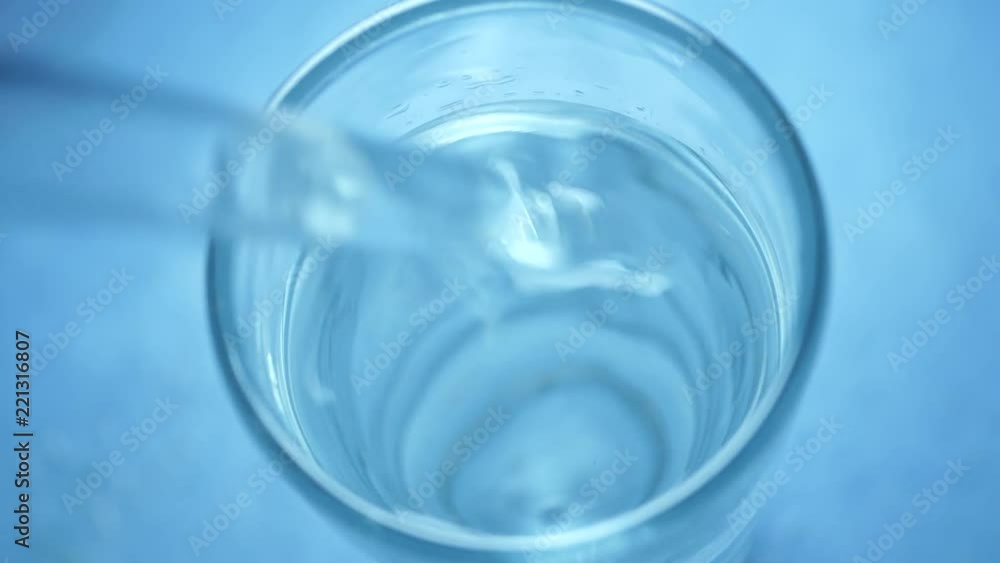 Stirring water slowly in a glass Stirring water slowly in a glass