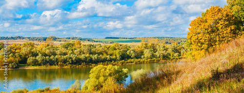 Panorama with autumn landscape. Golden autumn, river and blue sky