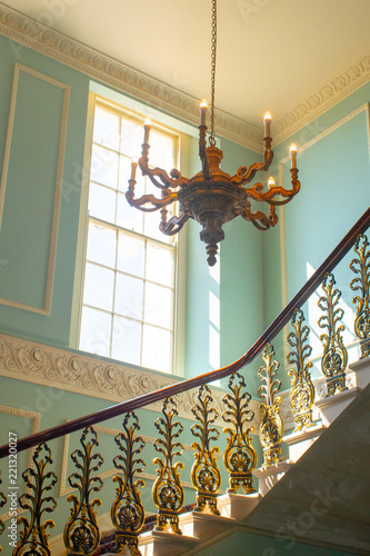 Georgian Stairway with chandelier hanging from the ceiling