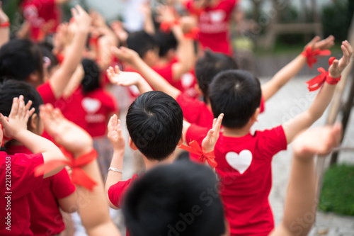 School children raising hands up