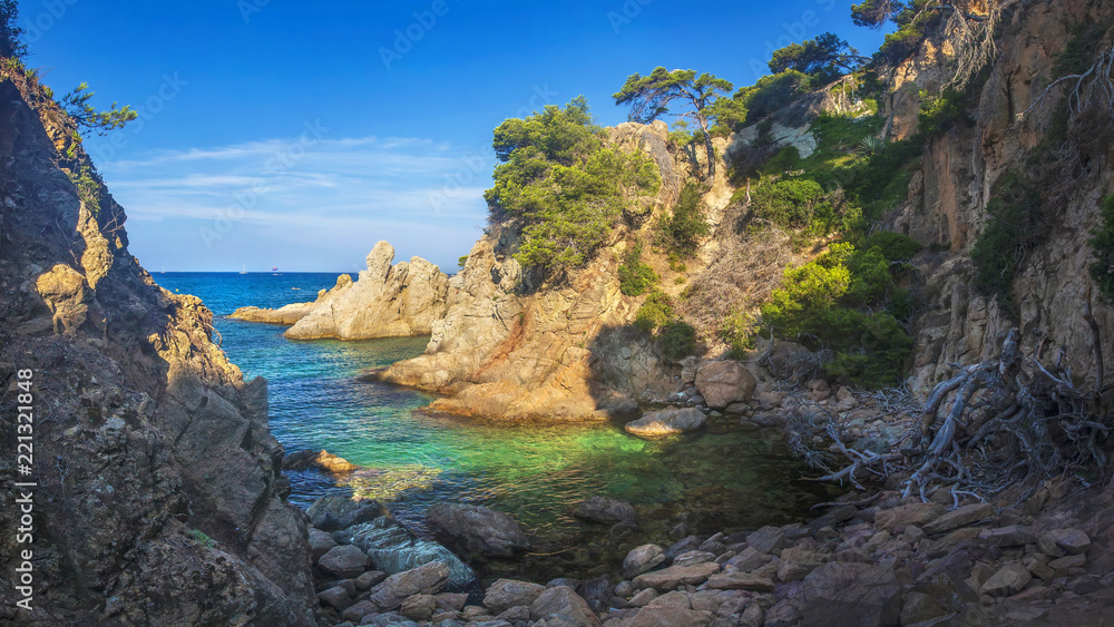 Wild seascape of bay in Mediterranean sea on clear sunny day. Amazing view of rocky shores against blue sky and coastline. amazing sea nature of Costa Brava, Spain. Landscape of Bay in Lloret de mar.