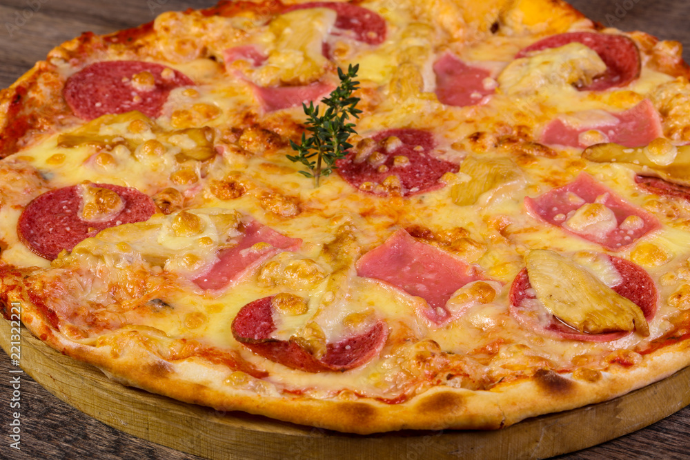 Pizza with ham and sausages Pizza with ham and sausages