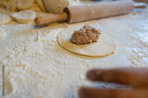 Making of kibinai - Lithuanian traditional pastry pie with meat.